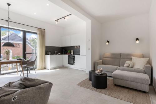 a living room with a couch and a table at Luxus-Ferienwohnung DS11 in Fehmarn