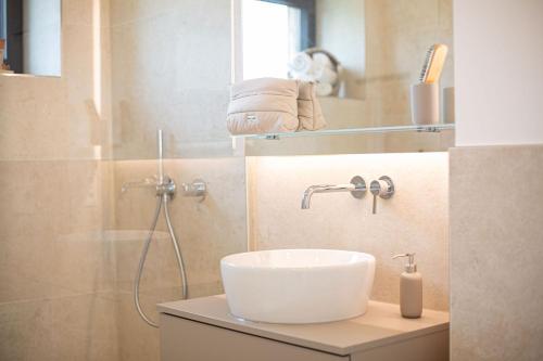 a bathroom with a sink and a shower at Luxus-Ferienwohnung DS11 in Fehmarn
