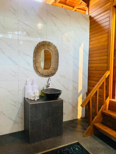 a bathroom with a sink and a mirror at Pandawa Villa Sidemen in Karangasem