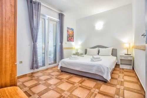 a bedroom with a bed and a large window at Apartment SM in Herceg-Novi