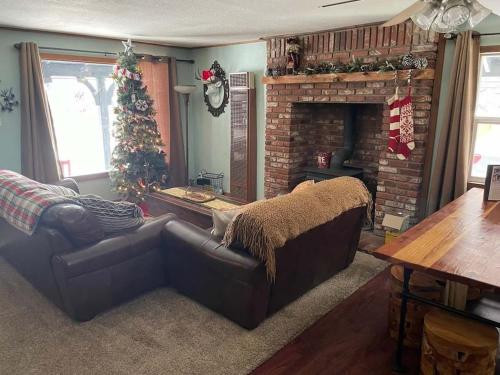 a living room with a couch and a christmas tree at THE OHANA at BIG BEAR in Big Bear City