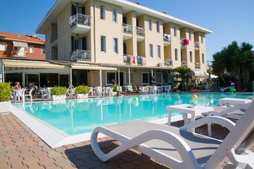 a swimming pool in front of a hotel at Hotel Delle Mimose in Diano Marina