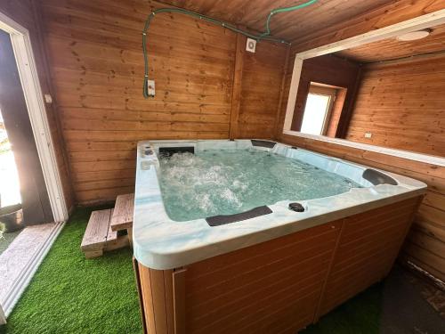 a large jacuzzi tub in a wooden house at carmel cabins suite 3 in Yājur