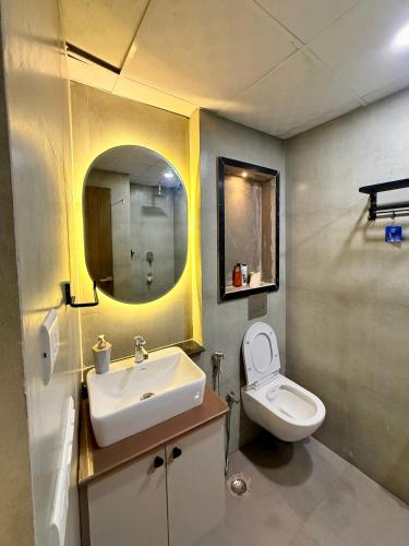a bathroom with a sink and a toilet at Nova Spira in Noida