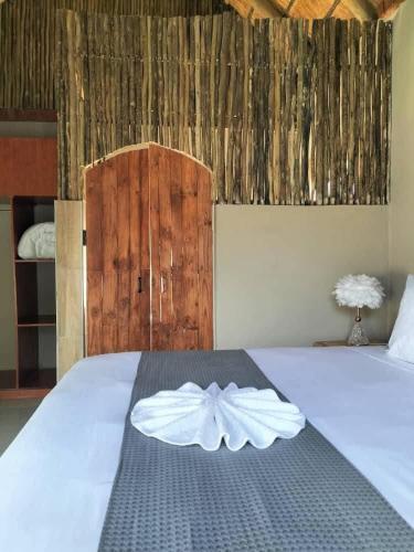 a bedroom with a bed with a white bow on it at Sofitel Inn in Maun