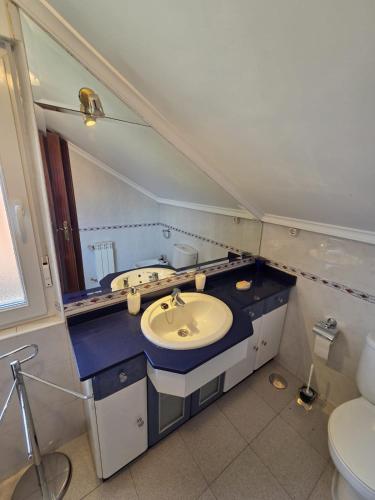 a bathroom with a sink and a mirror at Casa el Bosque in Camargo