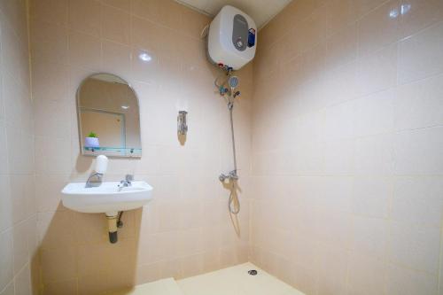 a bathroom with a sink and a mirror at Behomy J-Home Bandung in Bandung