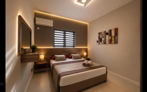 a bedroom with a bed and a mirror and a window at Beach luxury Penthouse in Flic-en-Flac