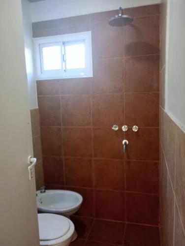 a bathroom with a toilet and a sink at La Dominga Tiny House in La Granja