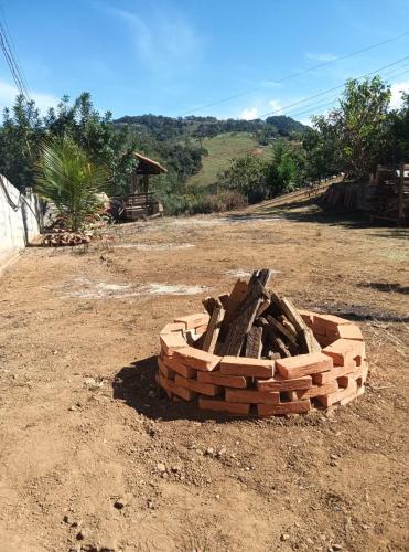 a stack of bricks sitting on a dirt field at Refúgio nas montanhas em Extrema com cachoeira in Extrema