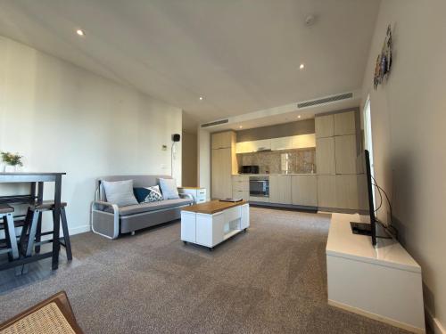 a living room with a couch and a table at Southbank Sanctum in Melbourne