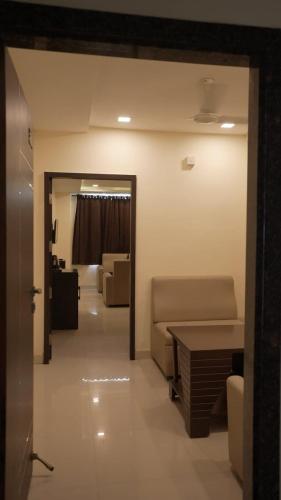 a living room with a couch and a table at Hotel Surya Teja Priime in Khammam