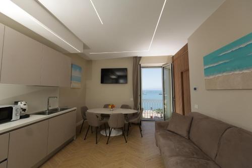 a kitchen and a living room with a couch and a table at Live in Gaeta in Gaeta