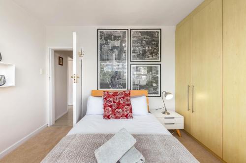 a bedroom with a large bed and two windows at Comfy Central with Balcony and Views in Cape Town