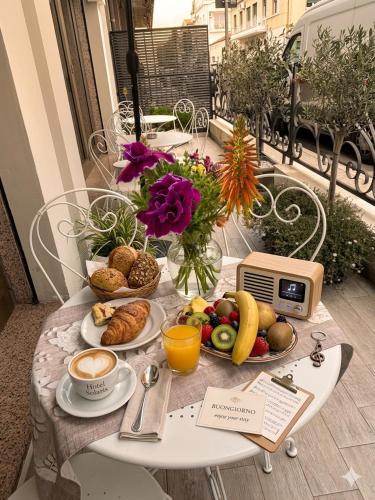 a table with breakfast foods and coffee on a balcony at Hotel Solaris in Giulianova