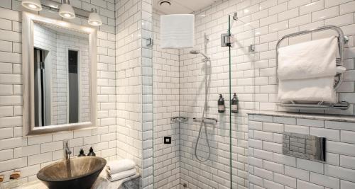 a bathroom with a sink and a shower at Hotel Kung Carl, WorldHotels Crafted in Stockholm
