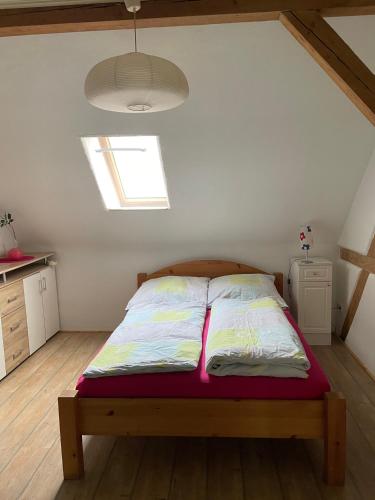 a bed in a small room with a window at Sternenblick in Neresheim