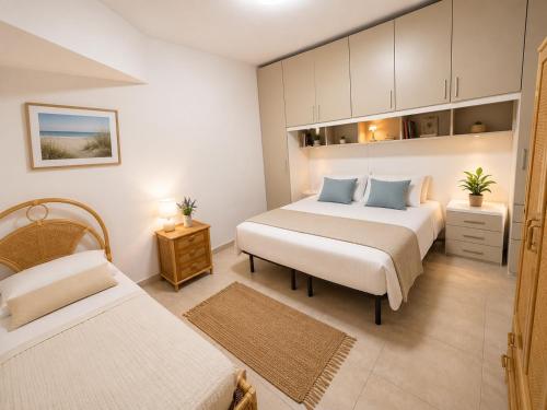 a bedroom with two beds and a cabinet at Belvedere Apartment in Casa Donato