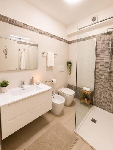 a bathroom with a sink and a toilet and a shower at Belvedere Apartment in Casa Donato