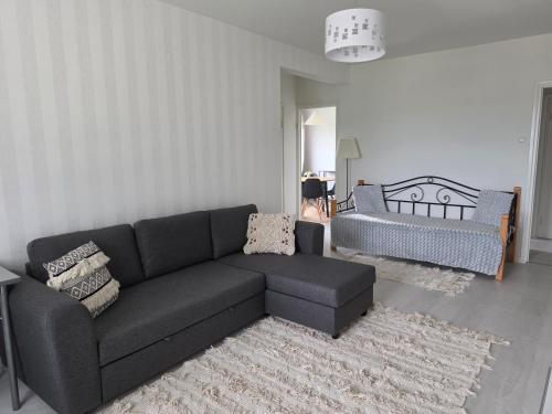a living room with a couch and a chair at Apartments at Koulukatu in Savonlinna