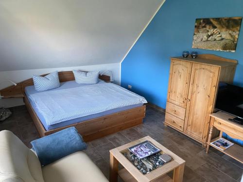 a small bedroom with a bed and a couch at Ferienwohnungen Arkonablick in Lohme