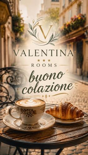 a table with a cup of coffee and a croissant at Valentina Rooms in Bronte