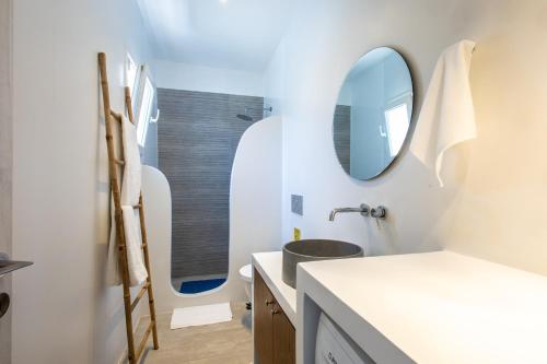 a bathroom with a sink and a mirror at Naxos Infinity Villa and Suites in Naxos Chora