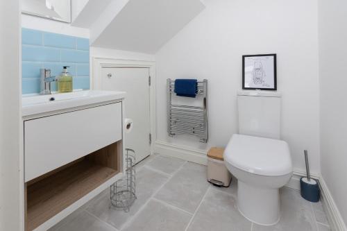 a bathroom with a toilet and a sink at Regent Street Residence Lutterworth in Lutterworth
