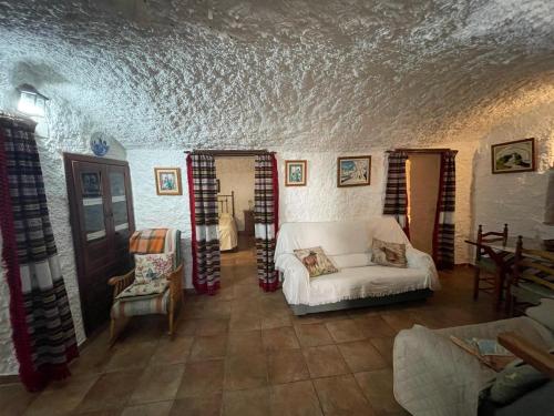 a living room with a white couch in a room at Las cuevas de María in Bácor
