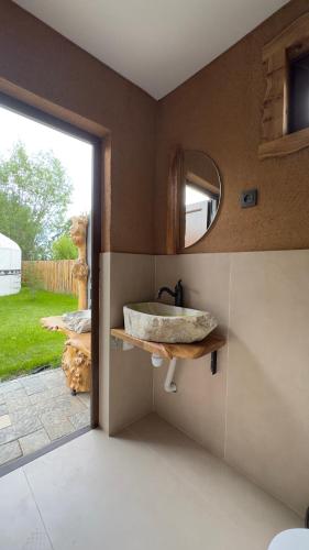 a bathroom with a sink and a mirror at Kurjun Guest House in Bokonbayevo