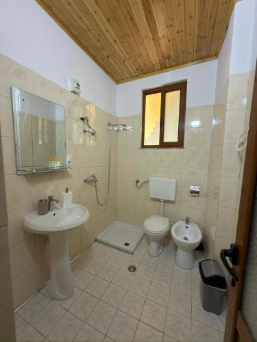 a bathroom with a toilet and a sink at Xhulio Guesthouse Berat in Berat