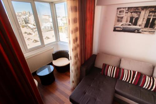 a living room with a couch and a window at Dor de Mare - Piata Ovidiu Constanta in Constanţa