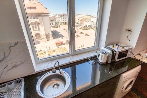 a bathroom with a sink and a large window at Dor de Mare - Piata Ovidiu Constanta in Constanţa