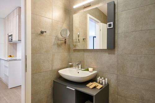 a bathroom with a sink and a mirror at Arancini Residence in Vodice