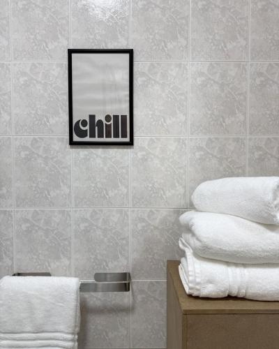 a bathroom with a mirror and a pile of towels at Maya Apartments in La Maddalena