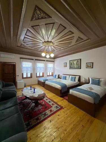 a large living room with two beds and a couch at Xhulio Guesthouse Berat in Berat