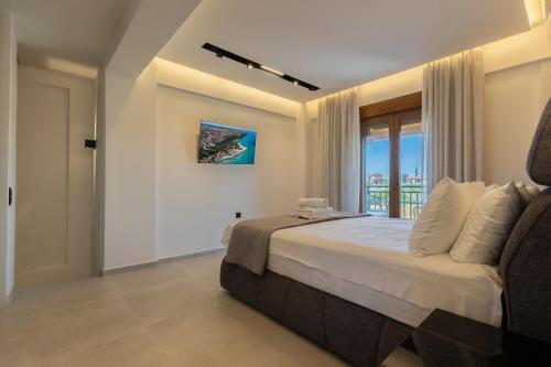 a bedroom with a large bed and a window at Afitos Luxury Villas in Afitos