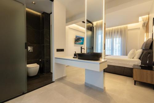a bathroom with a sink and a large mirror at Afitos Luxury Villas in Afitos