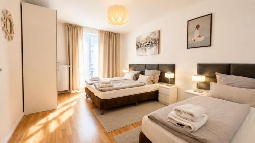 a bedroom with two beds and a large window at URBAN FLATS Berlin in Berlin