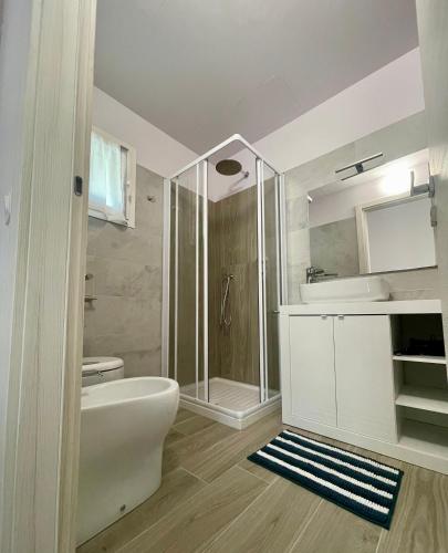 a bathroom with a shower and a toilet and a sink at Villa Giovanna Rooms in Montelabbate