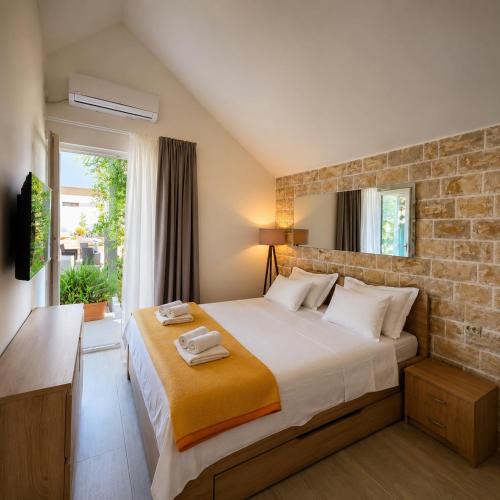 a bedroom with a bed with two towels on it at APARTMENTS JELENA 1,2,3,4 & 5 SUPETAR - free parking in Supetar