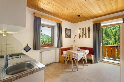 a kitchen and dining room with a table and chairs at THALERHOF Onach Dolomites - Kronplatz in San Lorenzo di Sebato