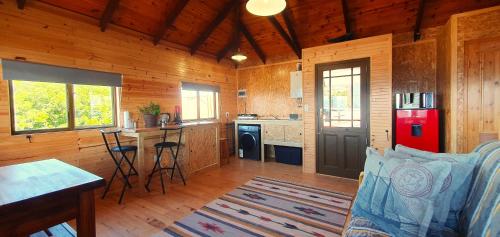 a kitchen with a red refrigerator in a wooden cabin at 7 on Kloof in Mossel Bay