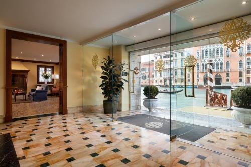 a lobby with a glass door and a potted plant at Sina Palazzo Sant'Angelo in Venice