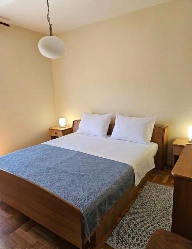 a bedroom with a large bed with white sheets and pillows at Rooms LuaMar in Sali