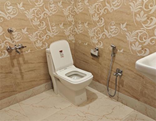 a bathroom with a toilet and a sink at Hotel Shreesh Mayapur in mayapur