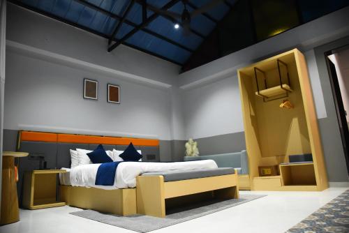 a bedroom with a large bed in a room at Chitra's City Side Resort in Solapur
