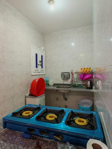 a kitchen with a blue stove top in a room at See you soon blue Beach in Marsa Matruh