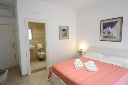 a bedroom with a bed with two towels on it at MELO 48 in Bari