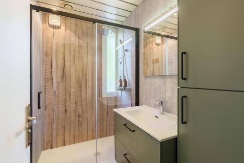 a bathroom with a sink and a shower at La Jardinette - Avec jacuzzi privé in Futeau